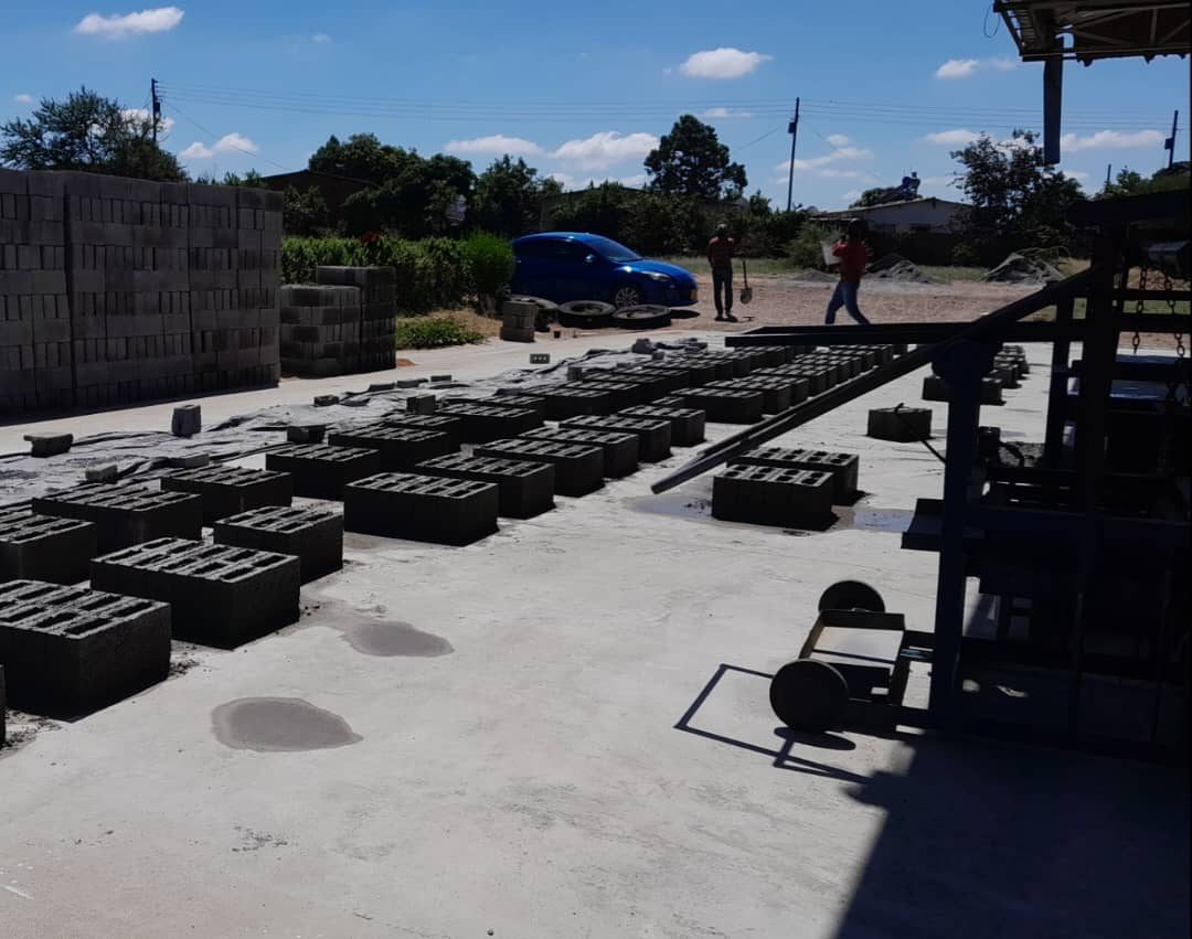 Blocks pressed and laid out beside the machine